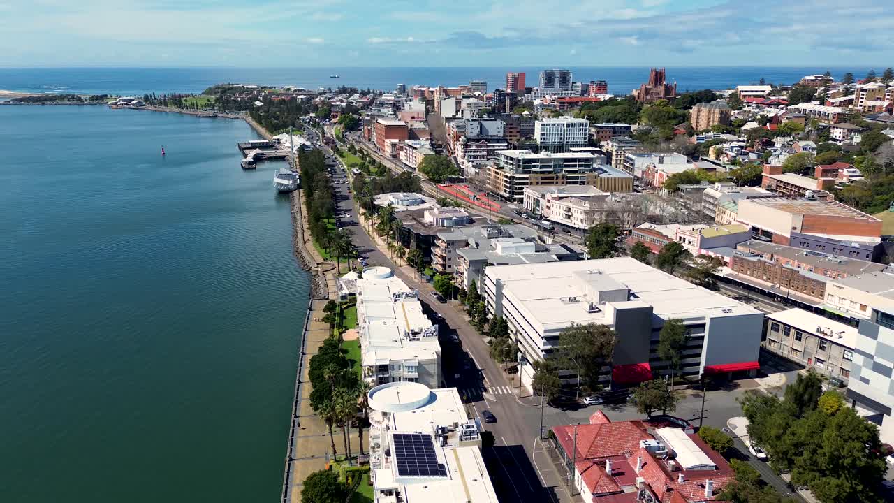 Drone aerial CBD city Newcastle Harbour Honeysuckle wharf Nobby's beach building Hunter River architecture NSW Australia 4K
