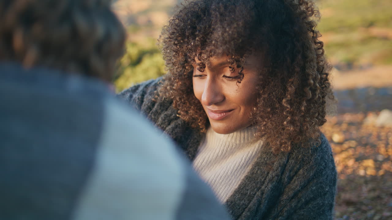 Curly girl lying grass nature closeup. Tanned woman talking unknown boyfriend