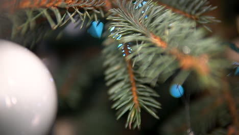 christmas tree leaf close up view with balls and ornaments, selective focus