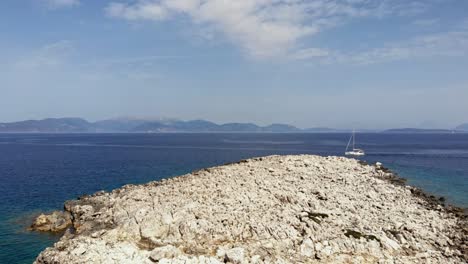 rocky coast of paralia emplisi beach in greece - aerial drone shot