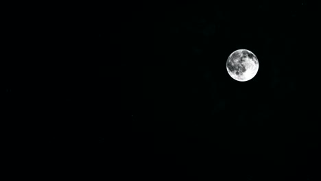 a bright full moon in a haze of smog. looped