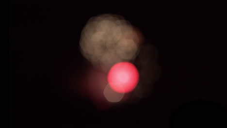 wide shot of bokeh patterns created by out-of-focus fireworks in the distance