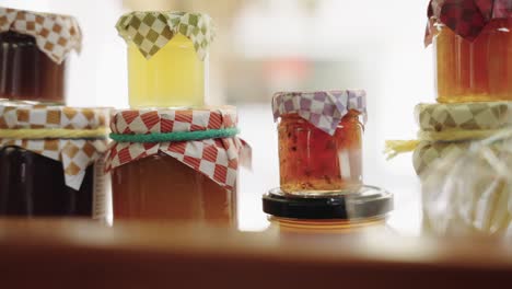 assorted jars of homemade marmalade in display case