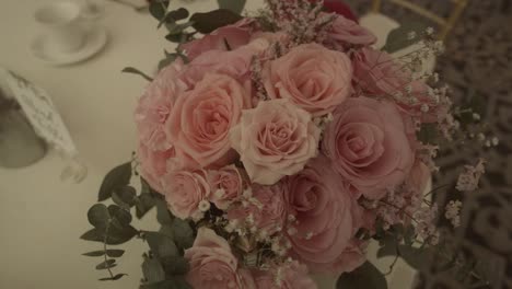 beautiful fresh bouquet pink rose flowers on elegant wedding table setting