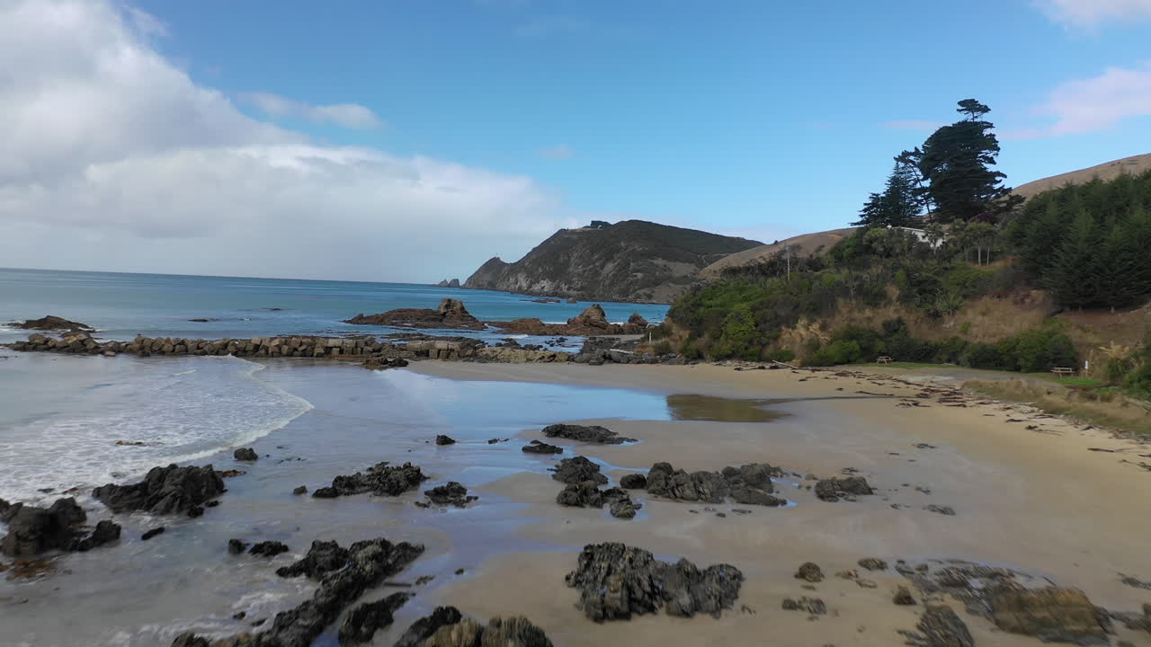 Scenic aerial view flying along a beach on the picturesque coastline of New Zealand