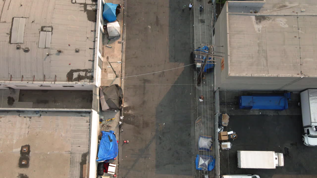 Aerial View of Urban Homeless Encampment with Tents and Vehicles