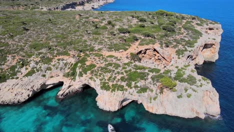 discover the breathtaking beauty of cala varques, located near porto cristo in majorca. experience the tranquil azure waters and rugged cliffs while enjoying nature's serenity.