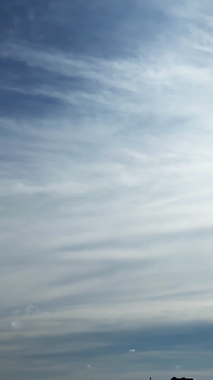 Rainy cloudscape spreading by the sky. Precipitation clouds formation. Low angle view. Vertical video.