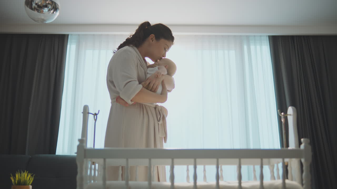 Loving Mother Holding Newborn Baby