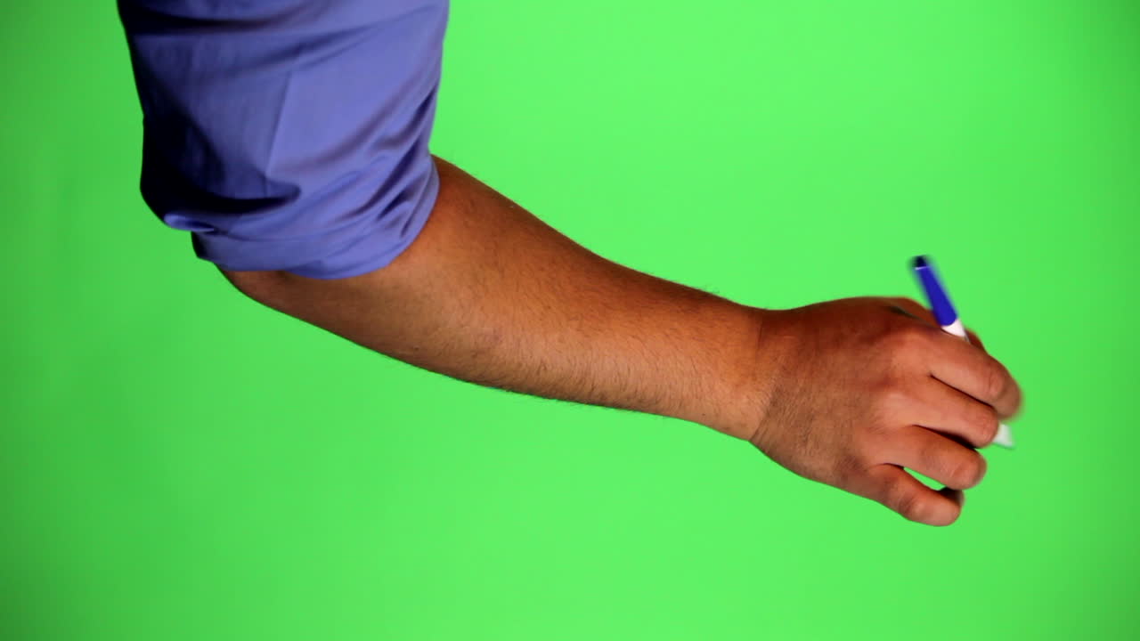 An arm in front of a green screen to be keyed and used at will. Rotate image for best results. Originally used for a few animated whiteboard videos. Blue marker pointing up and right.