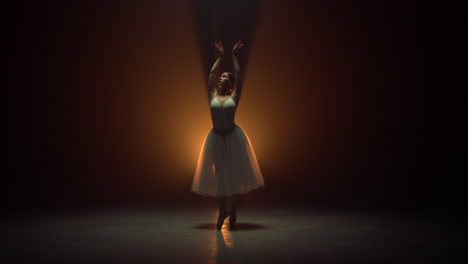 Flexible-ballerina-dancing-on-tiptoe-on-stage.-Ballet-dancer-wearing-tutu-skirt