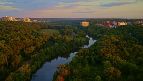 slow-moving drone footage showing ann arbor’s huron river in michigan during the summer.