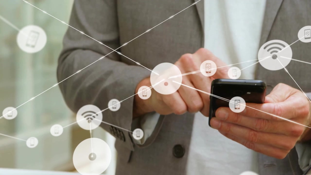 Businessman tapping smartphone in office, with floating connectivity icons showing IoT network