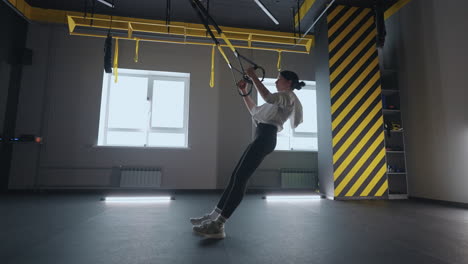 Fitness-Frau-Trainiert-Mit-Trx-Geräten-Im-Fitnessstudio.-Gesunder-Lebensstil,-Aufbau-Eines-Starken-Und-Fitten-Körpers.-Attraktive-Frau,-Die-Im-Fitnessstudio-Core-Bauchmuskel-Crossfit-Training-Mit-Fitnessgurten-Macht