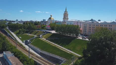 cityscape with historical buildings, park, and railway