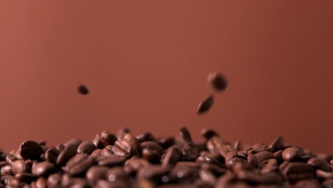 coffee beans pouring onto pile