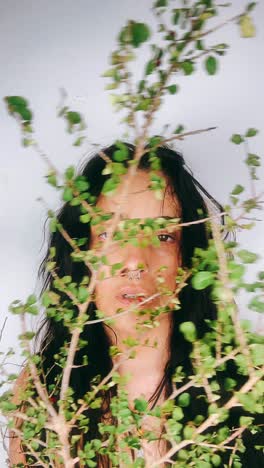 woman hidden behind plants