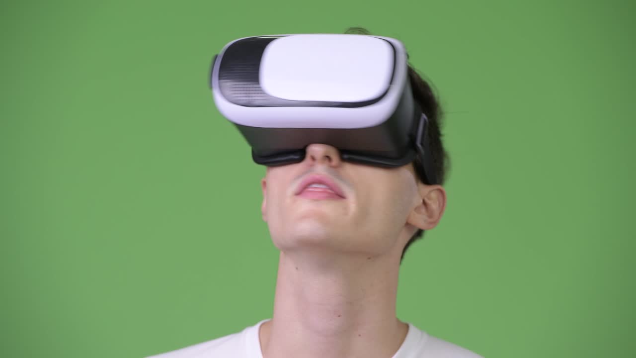 Young handsome man using virtual reality headset