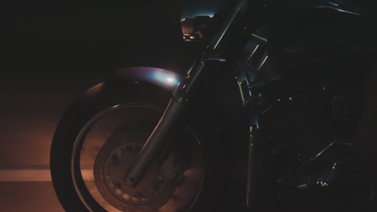 Close up of motorcycle security riders moving fast at night, rear brake light glowing red with license plate visible, leather gear and chrome engine parts reflecting road light
