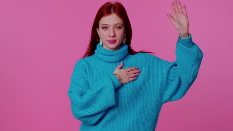 sincere responsible teen girl raising hand to take oath, promising to be honest and to tell truth