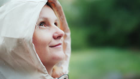 portrait of a young woman enjoying the spring rain looking up hiking and adventure freshness concept