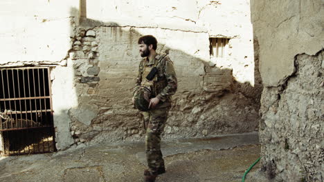 soldier puts on his hat before scouting the dangerous area