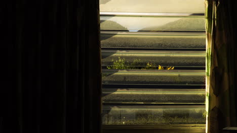 glass jalousie window with a view of queenstown mountains in south island, new zealand