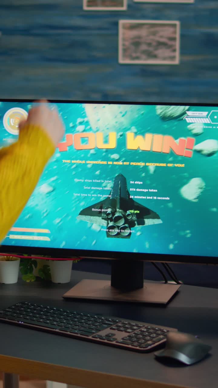 Vertical video: Happy professional cyber gamer winning video game