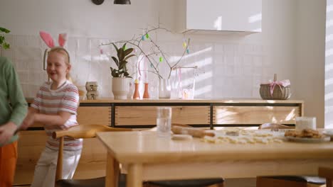 kids baking easter cookies in the kitchen