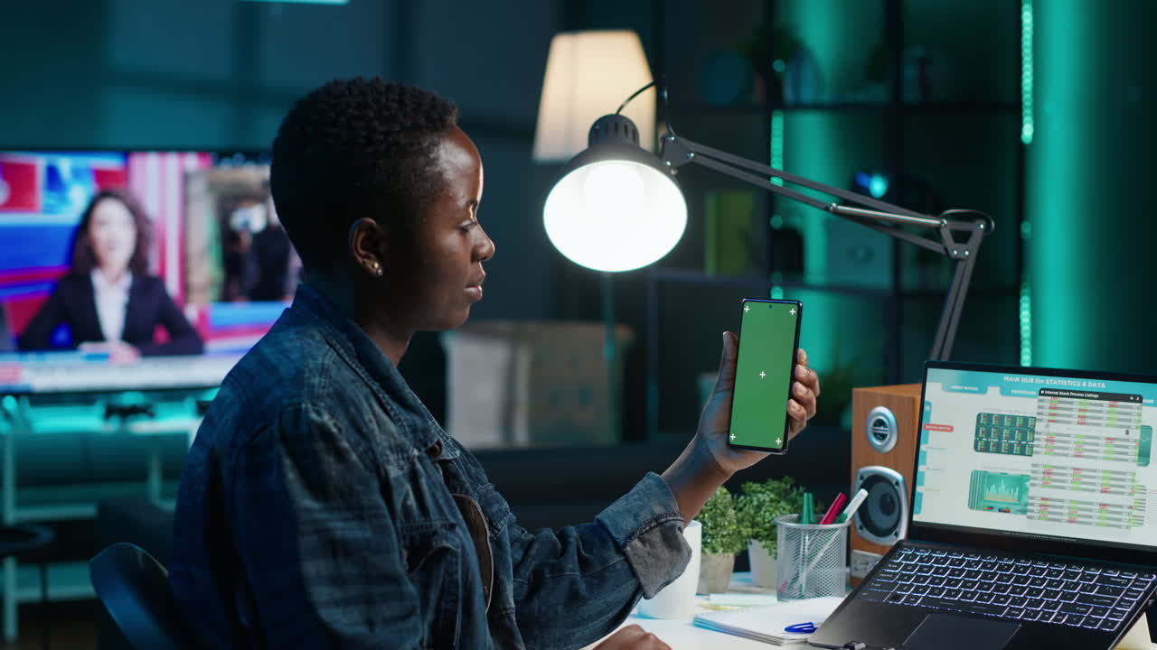 Woman using phone for online meeting at night