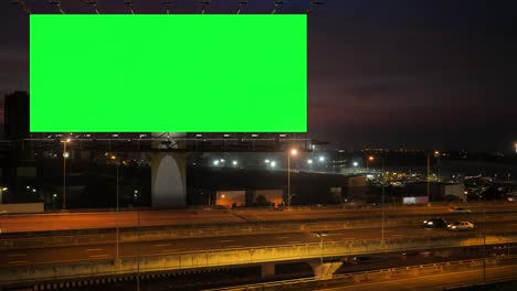 green screen of advertising billboard on expressway during the twilight with city background in bangkok, thailand.