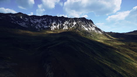 mountain scenery with snow and green slopes