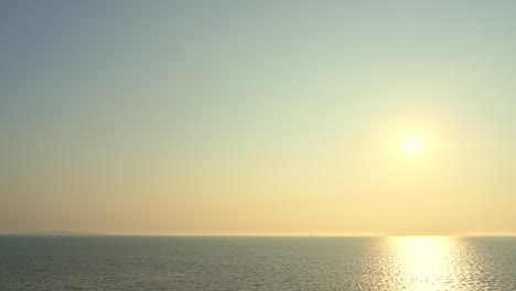 Endless-tranquil-seascape-on-yellow-golden-sunset,-sunlight-reflection-on-sea-water-surface