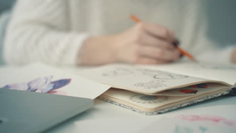 drawing illustrations in a notebook