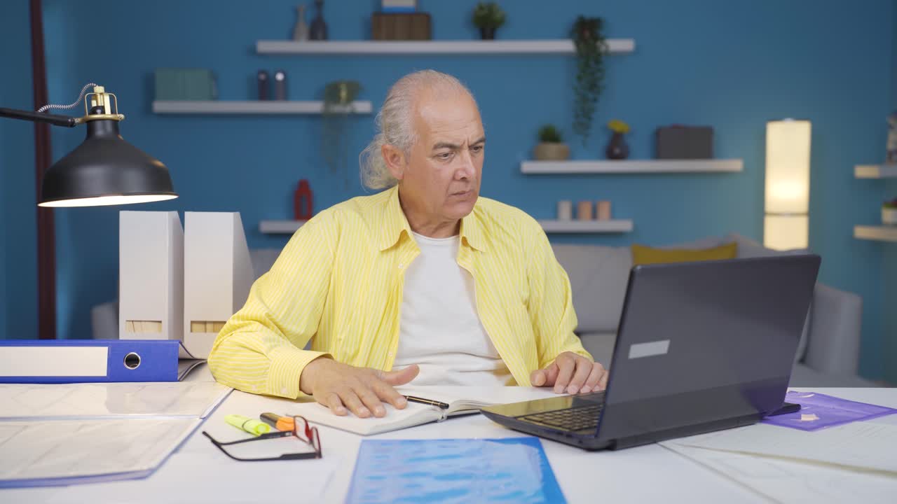 Home office worker old man working with concentration.