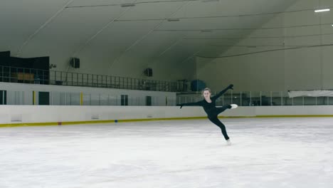 young woman skating and jumping on ice rink