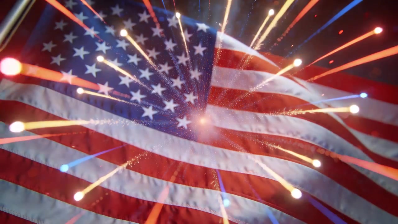 Spark igniting near US flag, flag rippling and reflecting colorful fireworks, with flagpole