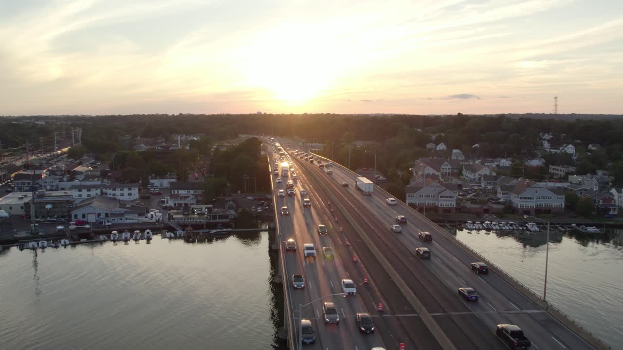 Drone Shot Tracking Forward over Interstate on Bridge at Golden Hour, with Moderate Heavy Traffic