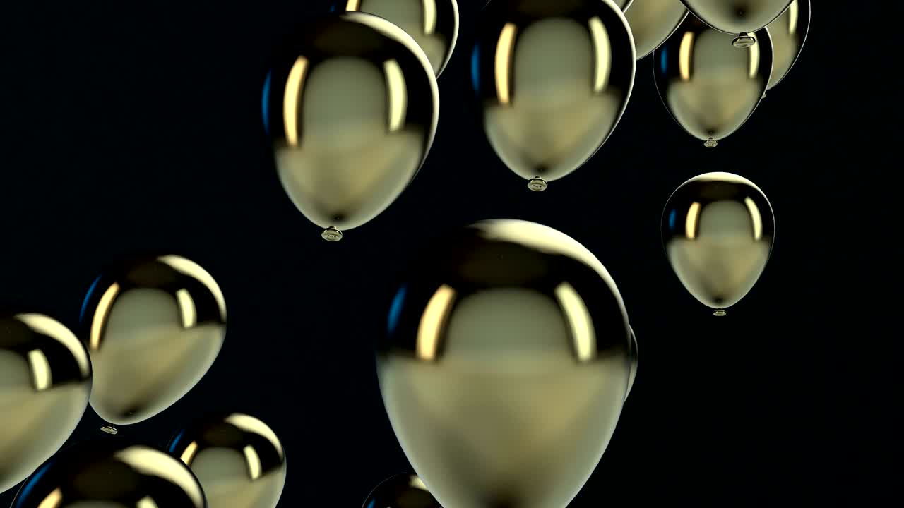 un globo dorado y negro flotando en el aire