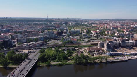 Aerial-drone-view-of-Barricaders-Bridge-crossing-Vltava-River-in-Prague,-Czech-Republic,-sunny-day-traffic