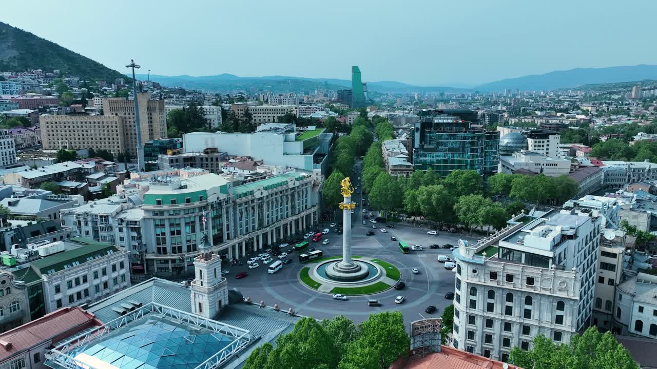 drone filmado para la plaza de la libertad en tbilisi, georgia, por la tarde antes de la puesta del sol al final de la primavera y el comienzo del verano cuando los árboles se ven verdes