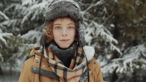 portrait of young woman in woods on winter day