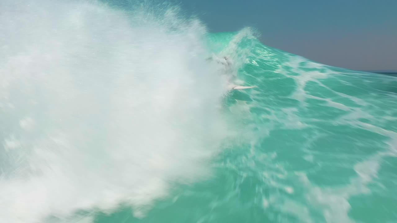 Slowmo Aerial View: Surfer Rides Massive Ocean Barrel Wave at Jervis Bay, Australia. Super Low Aerial Angle of Wave Crashing