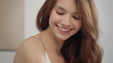 young woman body care at morning. portrait of happy woman applying body cream