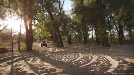 Man-tourist-driving-quadbike-on-sandy-road.-Traveler-driving-quad-bike