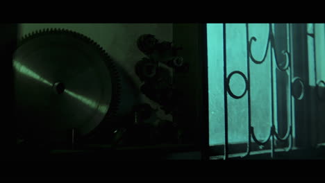dark workshop scene with saw and lantern