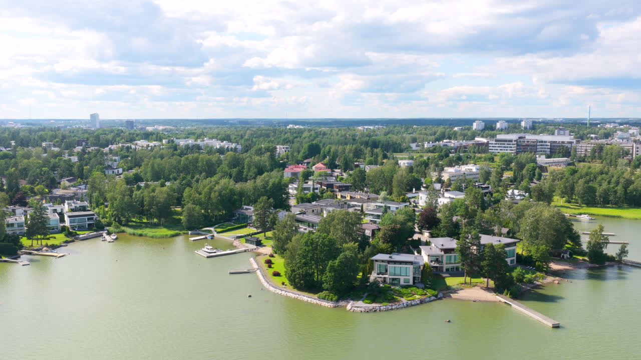 Drone circling the rich coastline of Westend, sunny, summer day in Finland