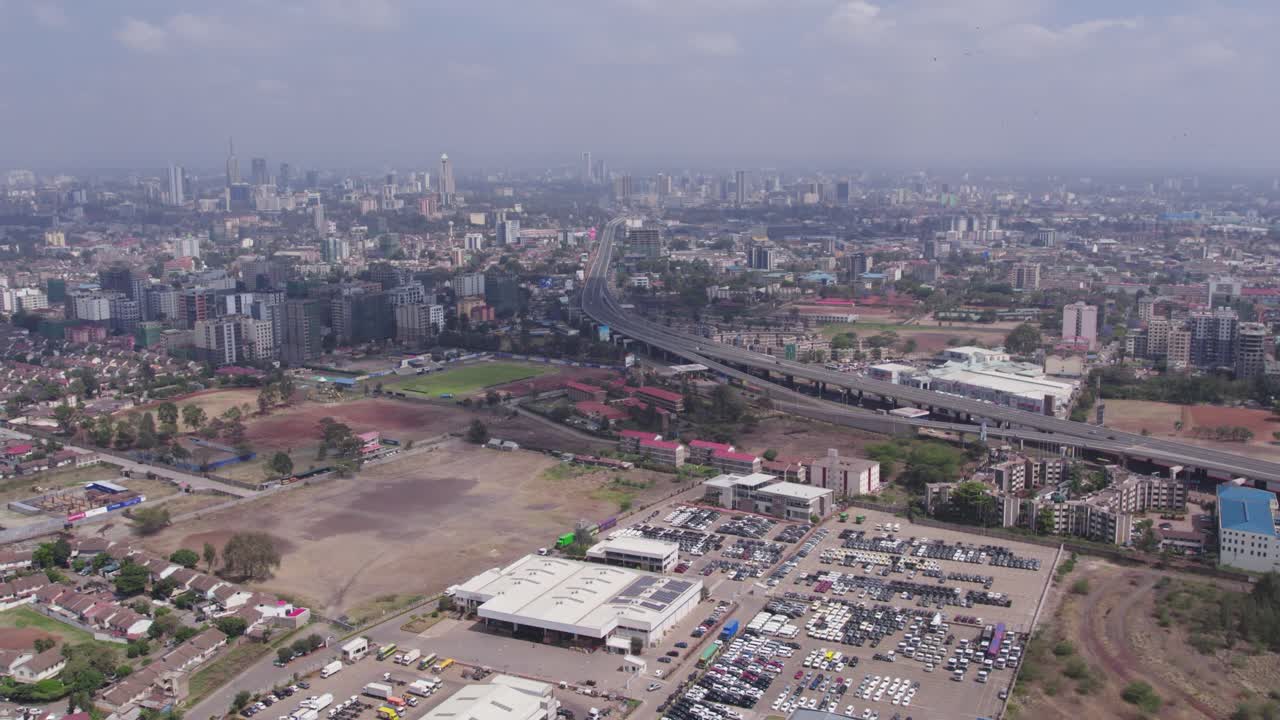 A beautiful aerial drone footage of the city of Nairobi, Kenya, showcasing the bustling urban office spaces, modern residential areas, the Nairobi Expressway, and Waiyaki Way. Captured during the day