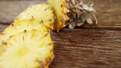 sliced pineapple on wooden plank