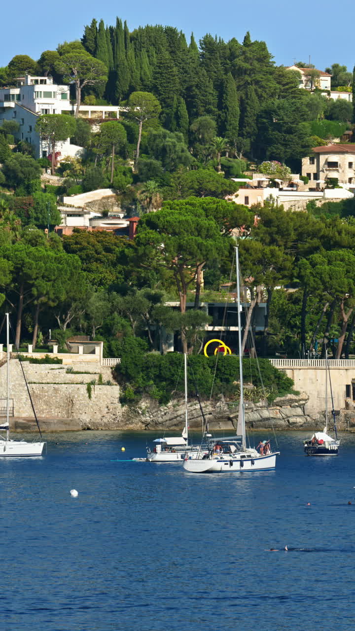 Boats docked in the local harbour in Villefranche sur Mer, France. Vertical